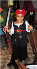 Young Pirate Smiles While Holding Sword