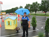 Officer With Umbrella Next to Course