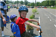 Child Smiles While Waiting on Bike