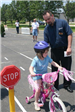 Child Waits at Stop Sign With Officer