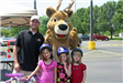 Children and Volunteer Pose With Moose Mascot