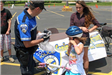 Officer Helping Child With New Helmet