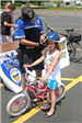 Police Officer Helps Child Put on Helmet