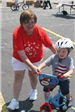 Taget Volunter Helps Young Boy on Bike