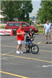 Target Employee Stands With Bike and Young Child