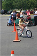 Young Girl Rides Bike Through Course