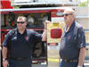 Fire Officials Stand Next to Truck