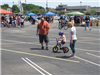 Parents Watch Child Ride Bike