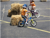 Young Child Rides Around Hay Bale