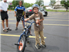 Young Boy Standing With His Bike