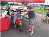 Kids on Bike Near State Farm Tent