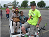 Man With Bike Cart Smiles With Participants