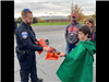 Officer passing out treat bags