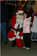 Santa Kneels With Young Girl