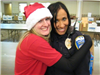 Volunteer and Officer Smile With Tables in Background