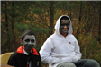 Boys With Paint on Face Sit Together
