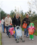 Families with Strollers Walking Down Lane