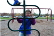 Girl Plays on Playground Equipment