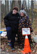 Volunteers Stand Near Cone and Sign