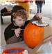 Young Boy Paints a Pumpkin