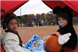 Young Children Hold Pumpkins