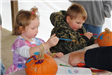 Young Children Paint Pumpkins