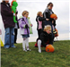 Young Girls Roll Pumpkin Down Hill