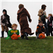 Young People in Costumes Holding Pumpkins