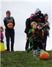 Young People Rolls Pumpkin Down Hill
