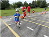 Safety Town Student Rides Scooter on Day 4 of Safety Town 2025