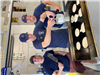 3 Firemen overtop a Griddle making Pancakes at the Copley Safety Center