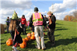 Officer Stands With Group and Pumpkins