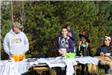 Volunteers Stand and Sit Near Table