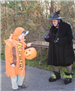 Woman in Witch Costume Giving Out Candy