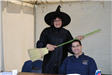 Woman in Witch Costume Smiles With Volunteer