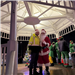 A man wearing reflective safety clothing is standing next to santa underneath the Copley Circle Gazebo