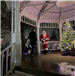 A man is seen standing on the Gazebo stage with Santa Claus and a Christmas Tree