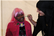 Young Girl Smiles While Getting Face Painted