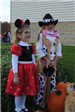 Young Girls Smile for Camera Near Pumpkins