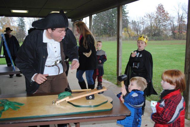 Volunteer Helps Child in Activity