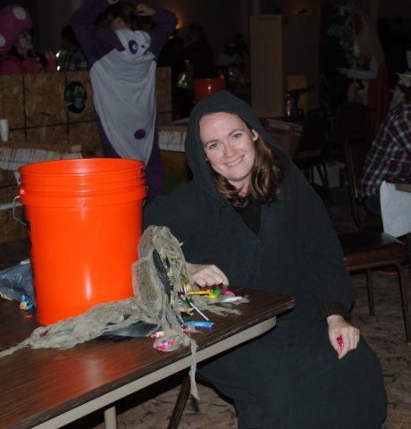 Volunteer in Costume Next to Table