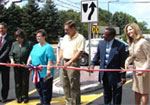 Community Leaders Cutting a Ribbon on a Street