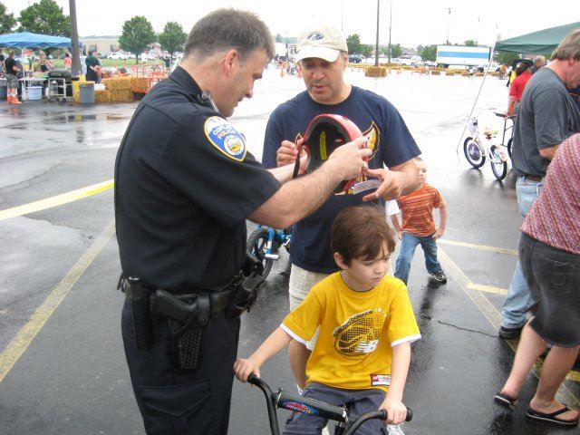 Community Member and Officer Talking About Helmet