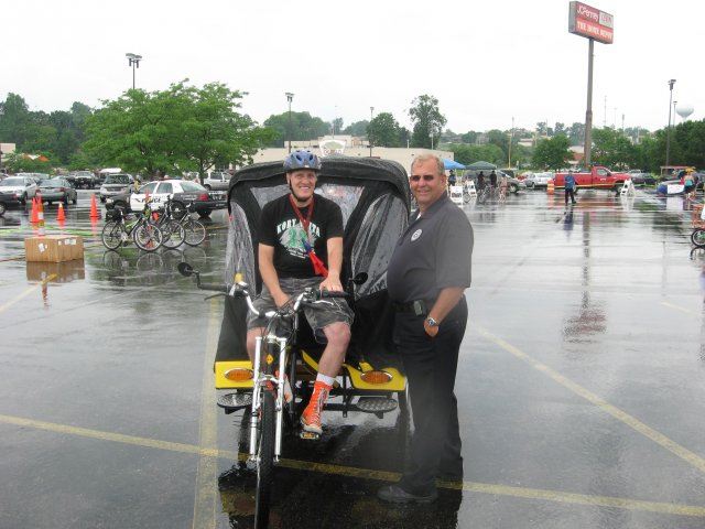 Community Member on Bike Smiles with Officer