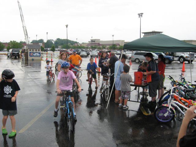 Community Members Gather With Bikes at Table