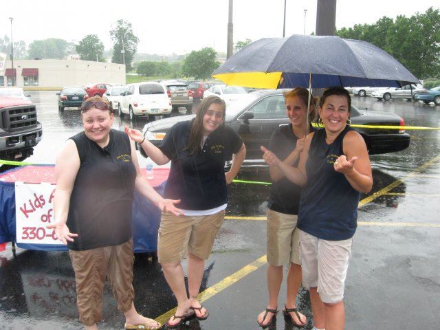 Group of Volunteers Posing for a Picture in Rain