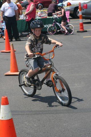 Young Boy Rides Bike Through Course