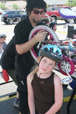 Young Girl Makes Funny Face While Bike Gets Worked On