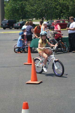 Young Girl Rides Bike Through Course