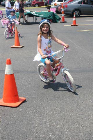 Young Girl Smiles as She Drives Through Course